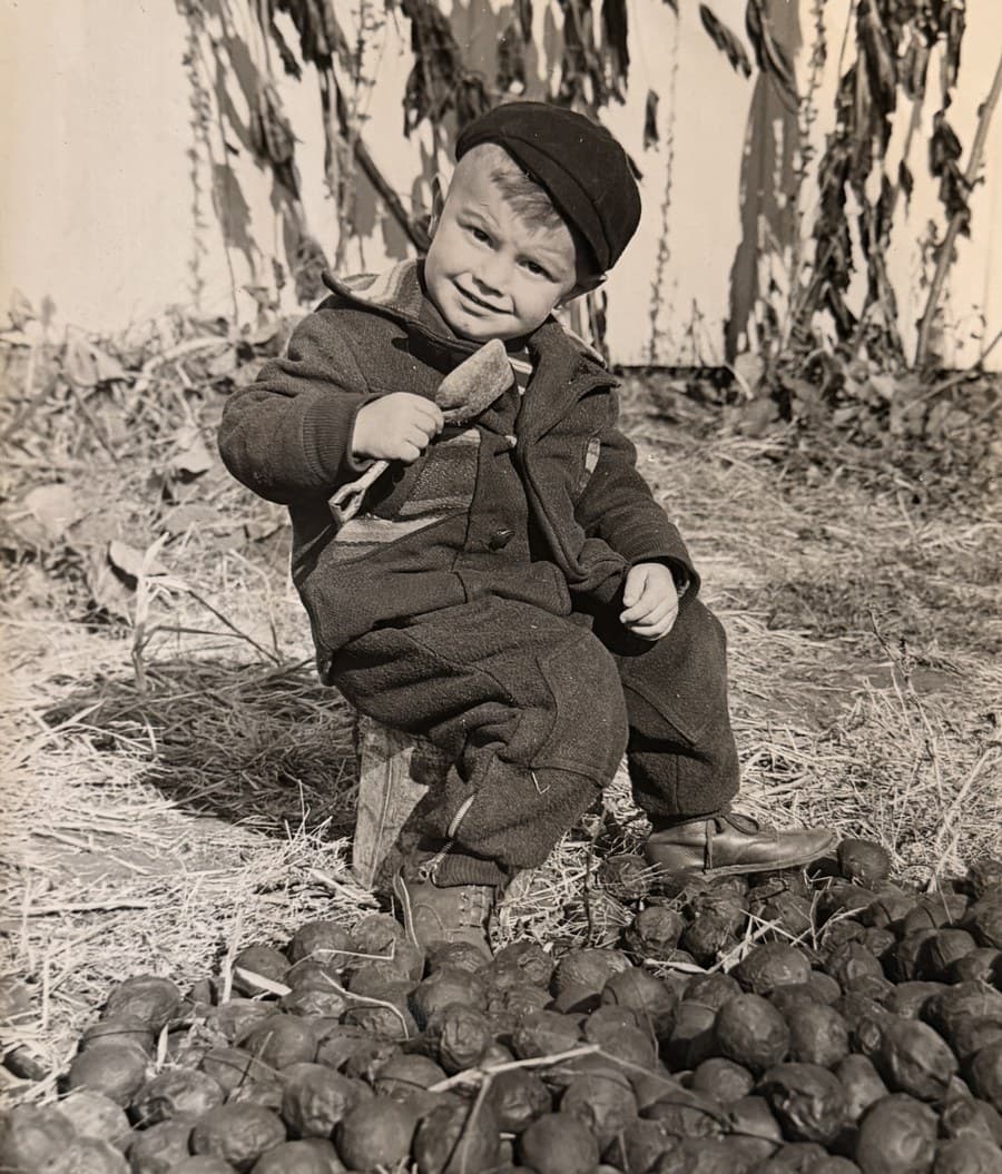 David Lloyd Fisher as a young child in the 1940s, sitting with walnuts — Columbus Ohio